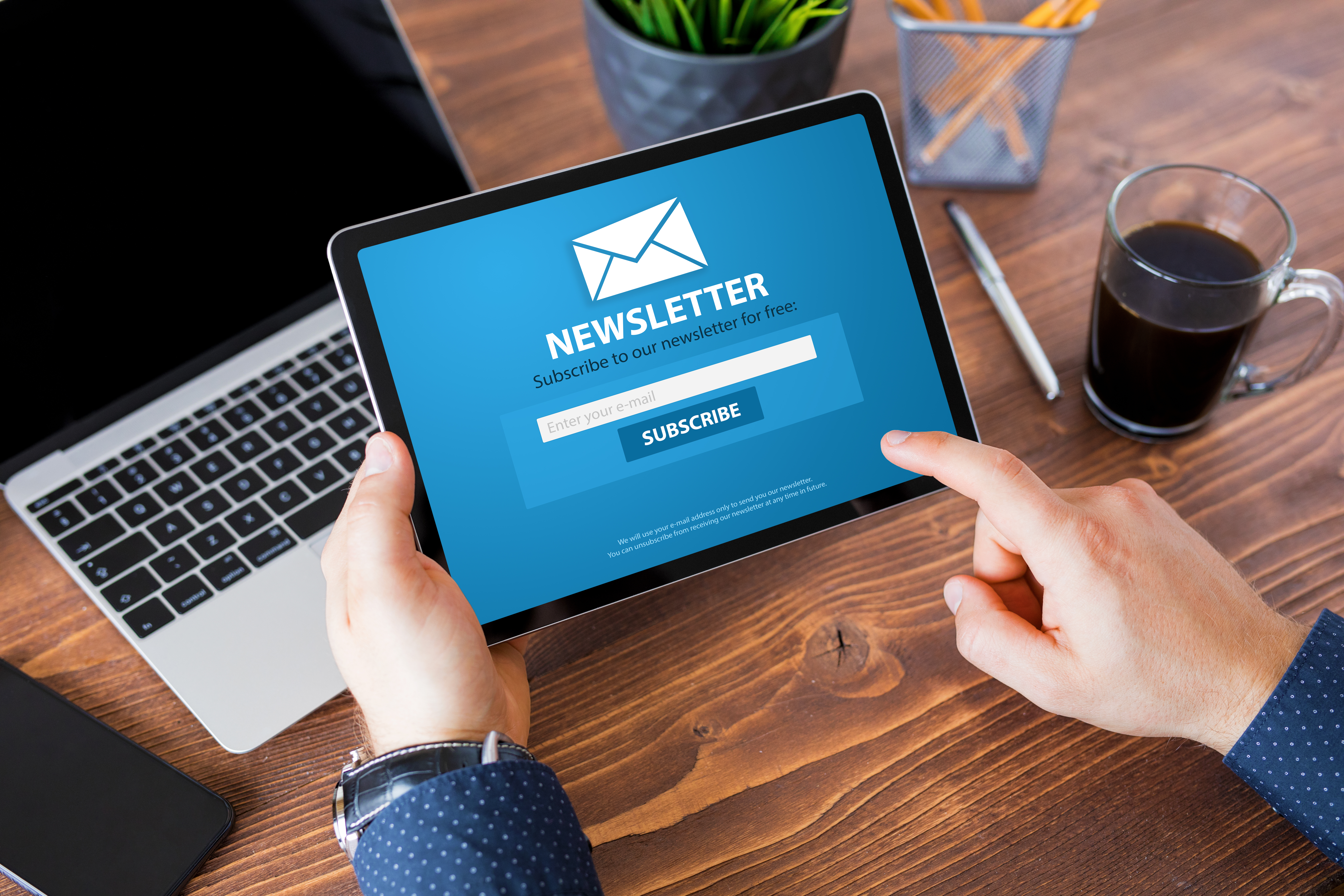 Man viewing newsletter signup page on tablet computer