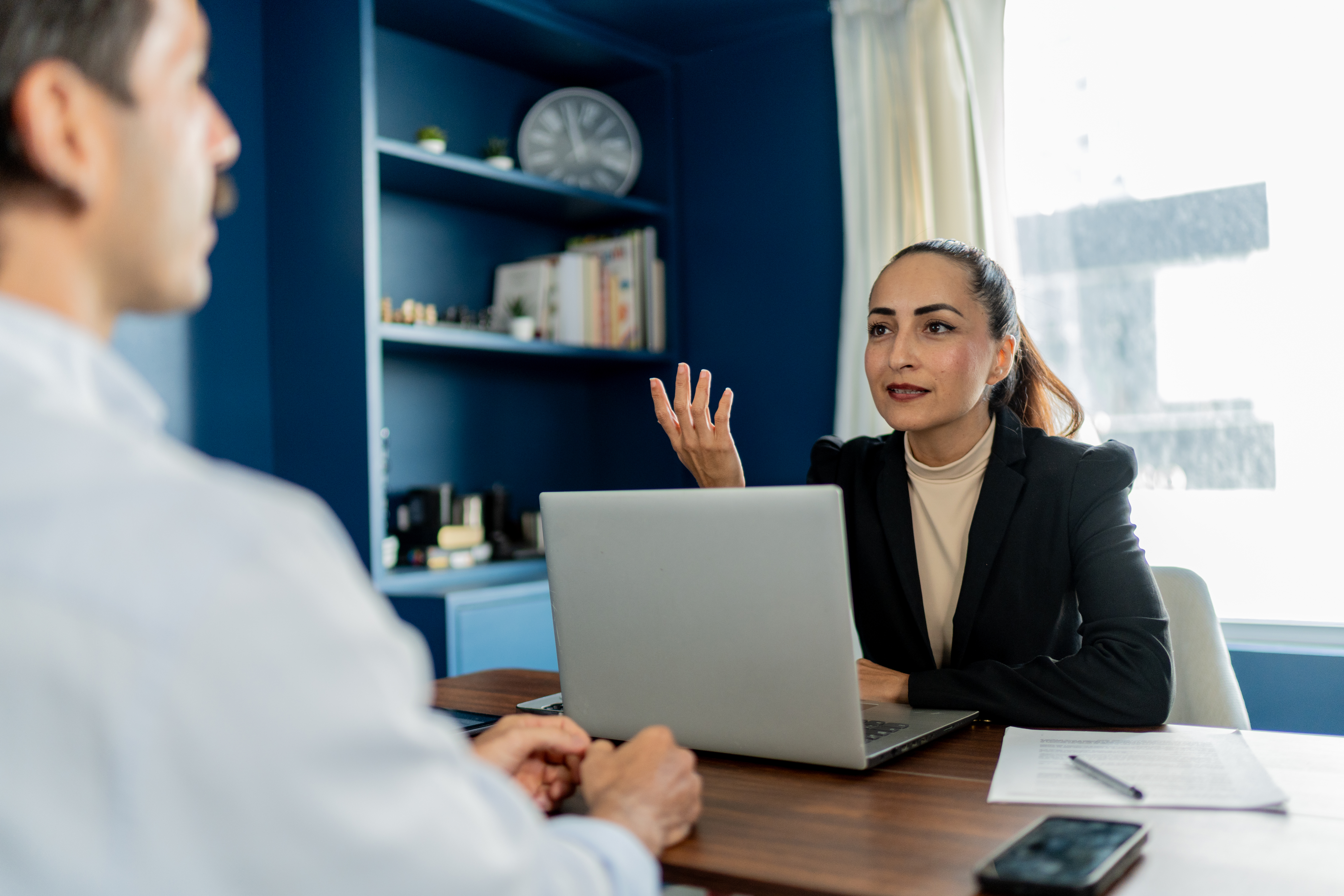 Attorney talking to client at law firm