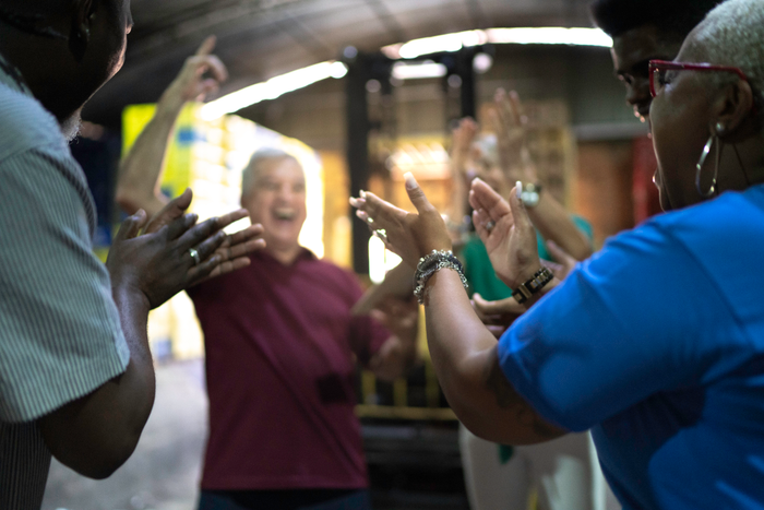 Happy employees celebrating together at warehouse