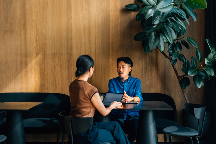 Colleagues Engaged in a Business Meeting at a Modern Cafe