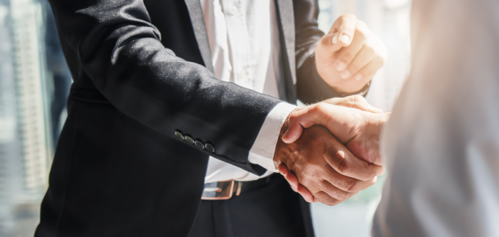 Two ethical businessmen shake hands.