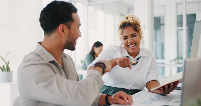 Happy business people, fist bump and celebration in partnership, teamwork or promotion together at office. Man and woman or friends touching hands in winning, greeting or friendship at workplace