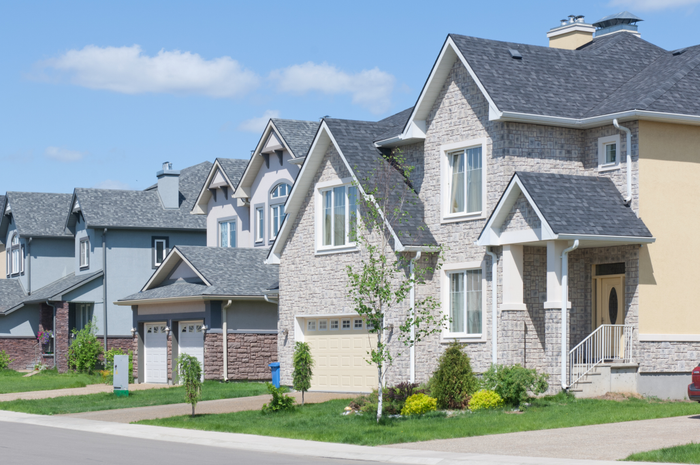 Newly built homes with attached garages and driveways