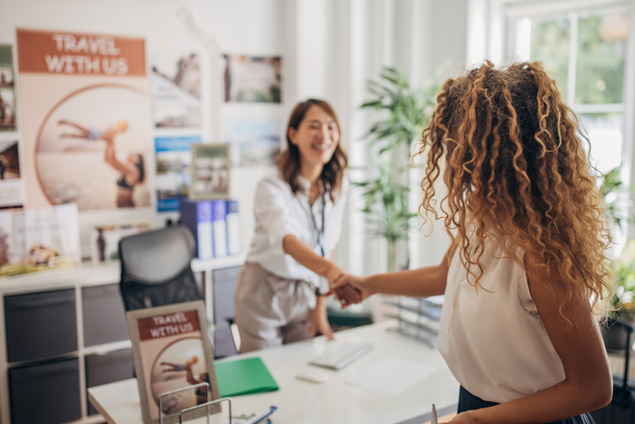 Woman arriving in travel agency