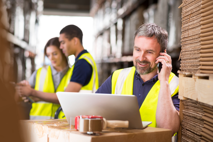 warehouse manager ringing a customer