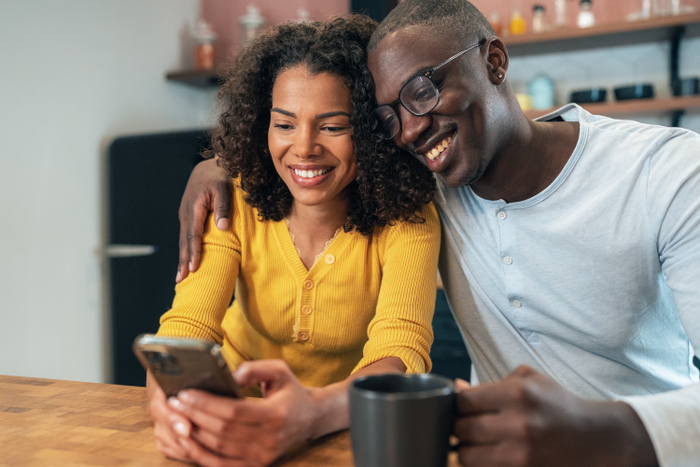 Happy couple looking at phone together