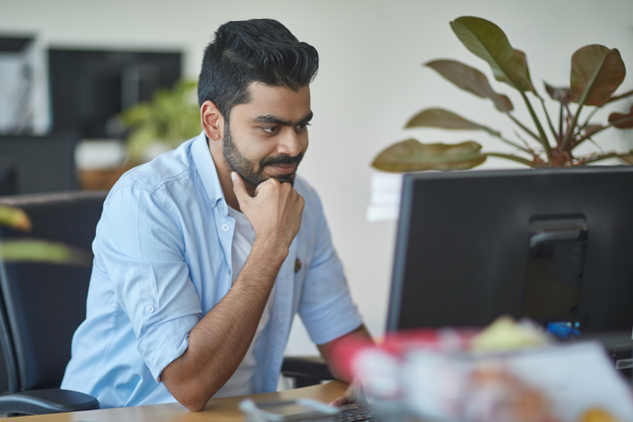 Businessman smiling while using computer