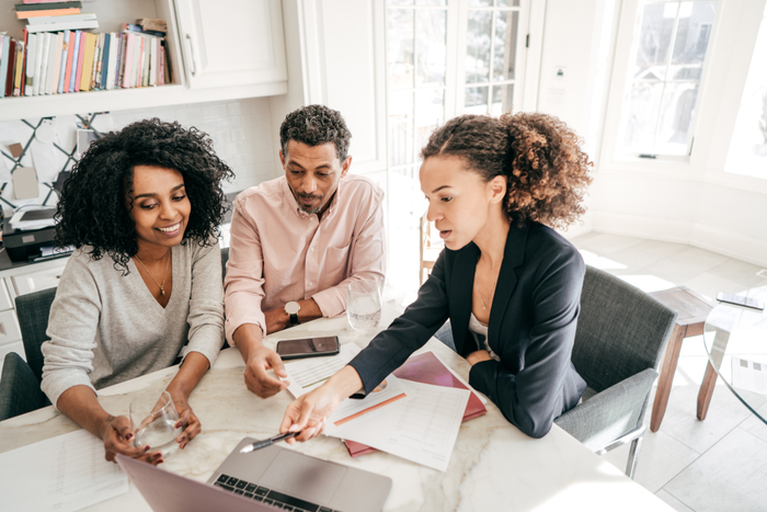 Business woman assisting couple with accounting services