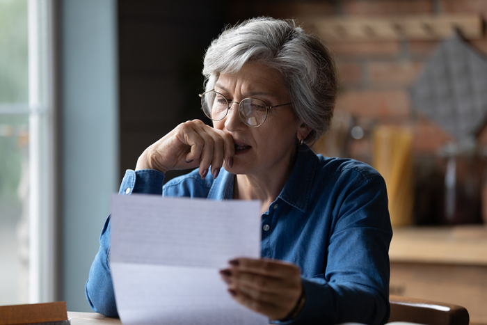 Stressed older latin woman get bad surprise reading official letter