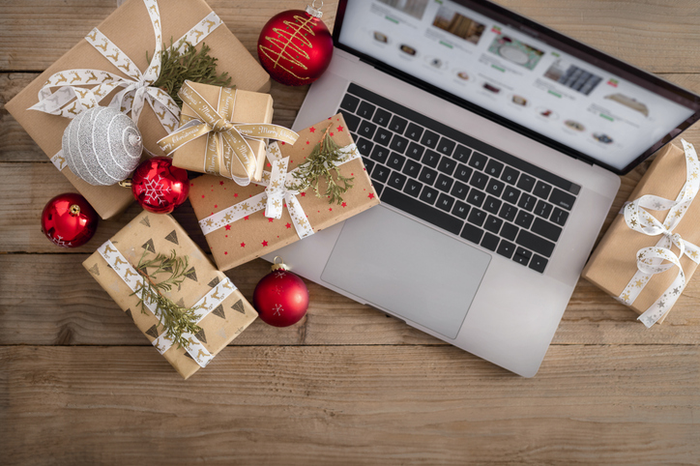 Laptop with Christmas gift boxes and balls Holiday sale shopping