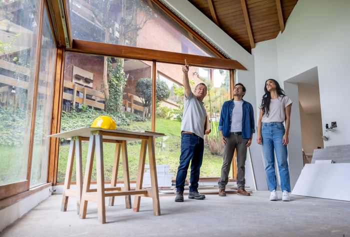 Building contractor talking to clients renovating their house