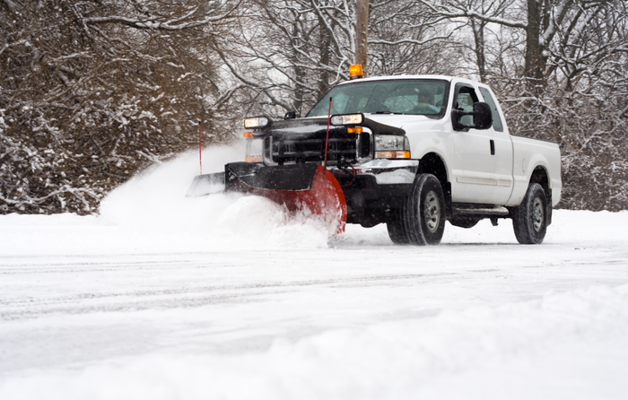 Truck plowing a snowy road