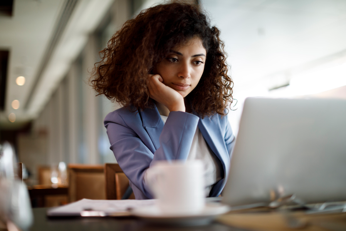 Businesswoman working on laptop at a cafe