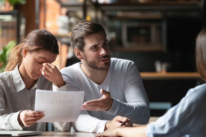 Angry young couple complaining, bad contract terms, arguing with manager