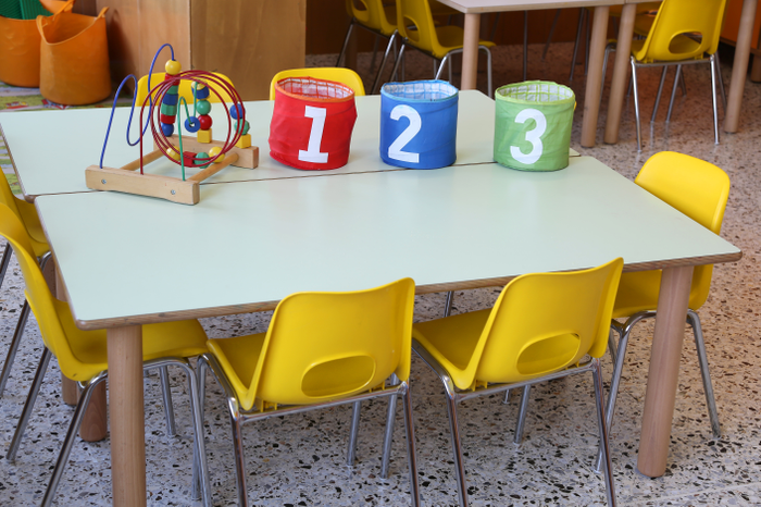 three colorful jars with drawn numbers on the school table