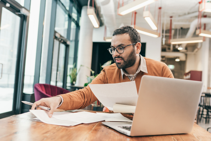 Man looking at paperwork confused