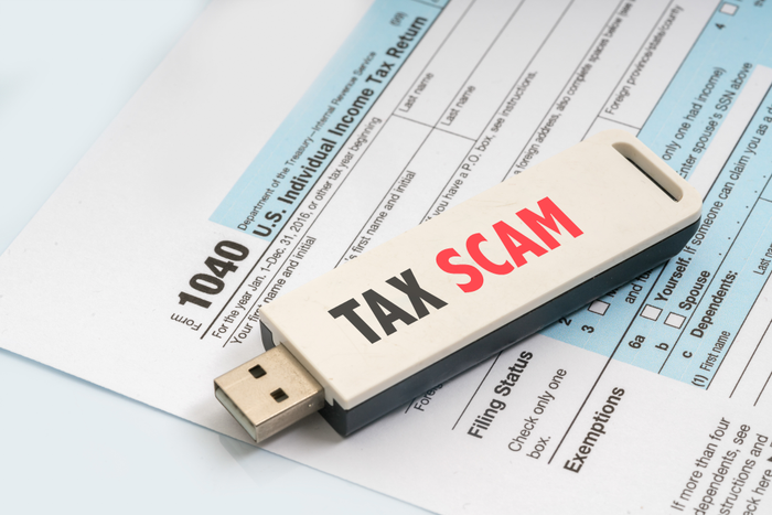 thumb drive marked 'tax scam' with tax forms
