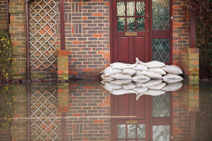 front door of house blocking flood with sandbags
