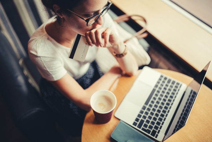 Woman looking anxiously at computer