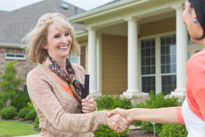 Mature real estate agent meeting future homeowner
