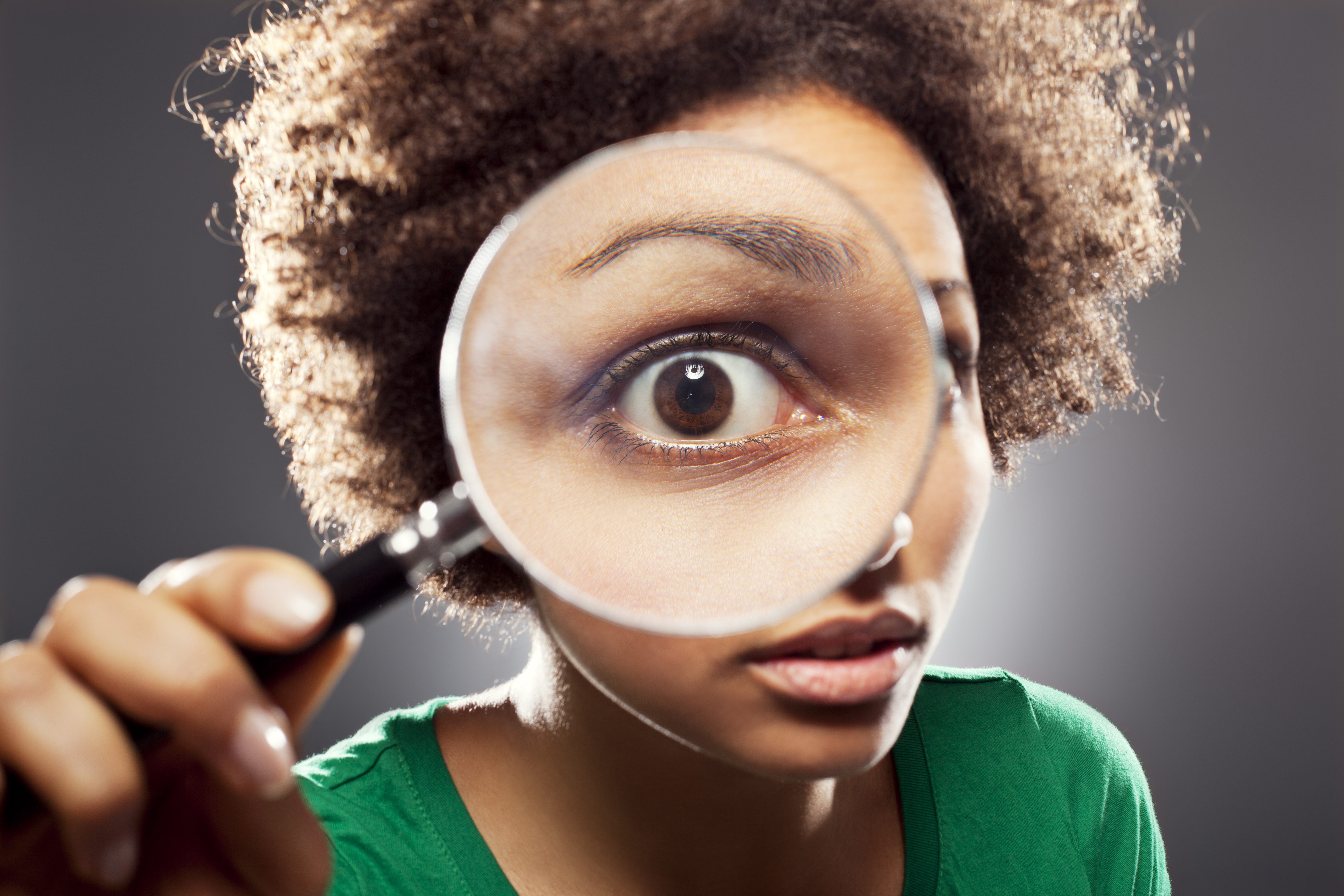 Young woman with a loupe