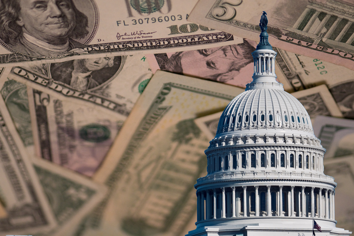 image of capitol building against background of paper money