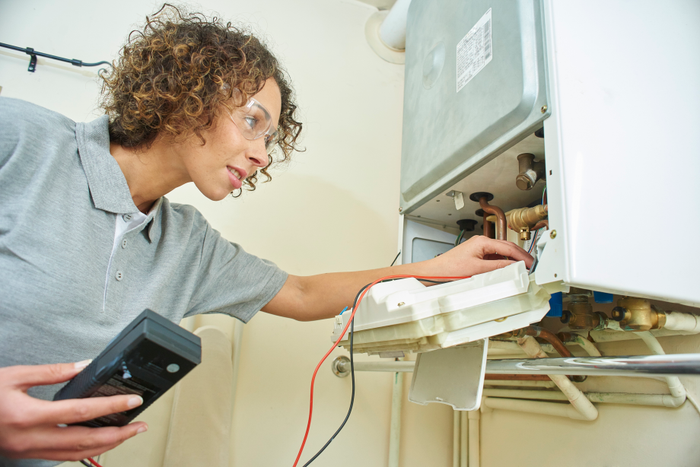 female plumber with central heating