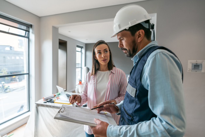 Woman talking to a contractor while remodeling her house