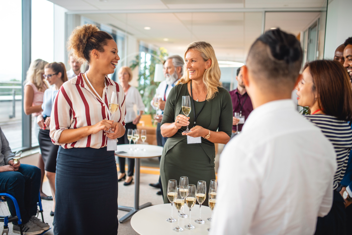 Businesspeople Gathered Around Champagne Table