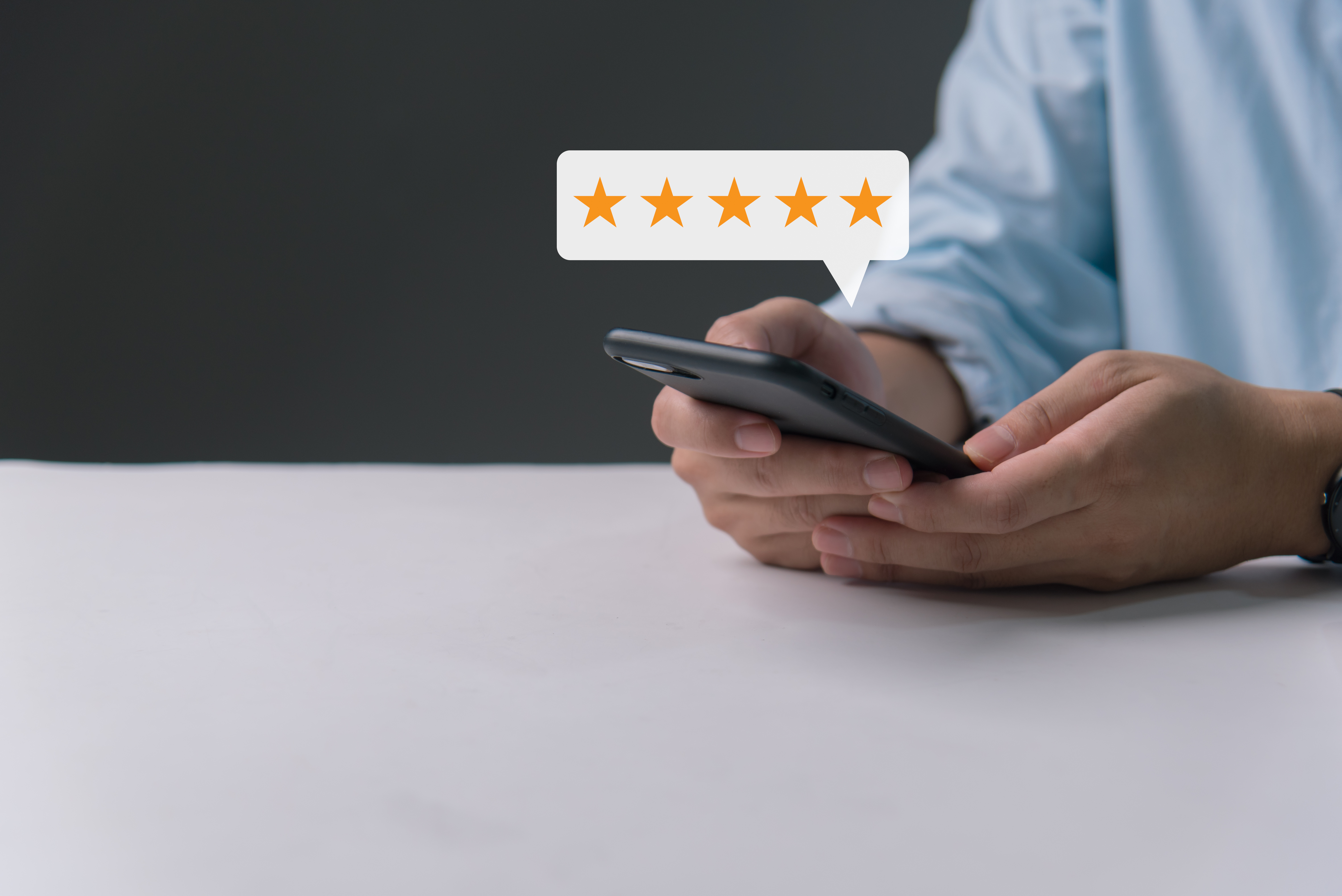 Customer review satisfaction feedback survey concept, man hand pressing on smartphone screen with gold five star evaluate quality of service ranking of business.