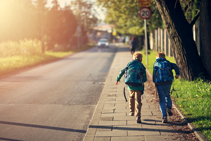 School boys running to school