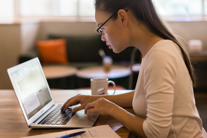 Woman working on her computer at home. Online business.