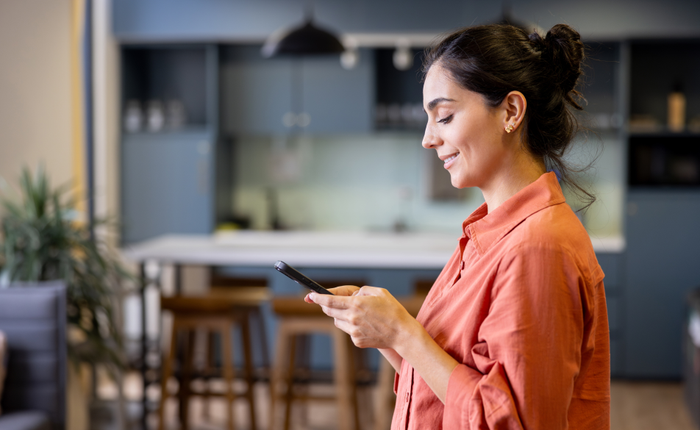 Business woman texting on her cell phone at the office